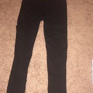 Black stretchy leggings with mesh rips.